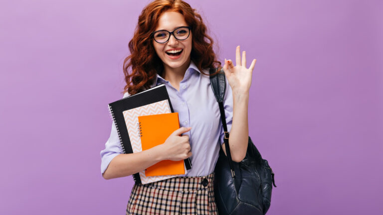 Happy student woman shows OK sign