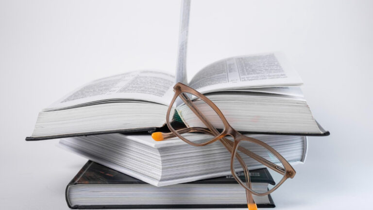 Books stack with eyeglasses